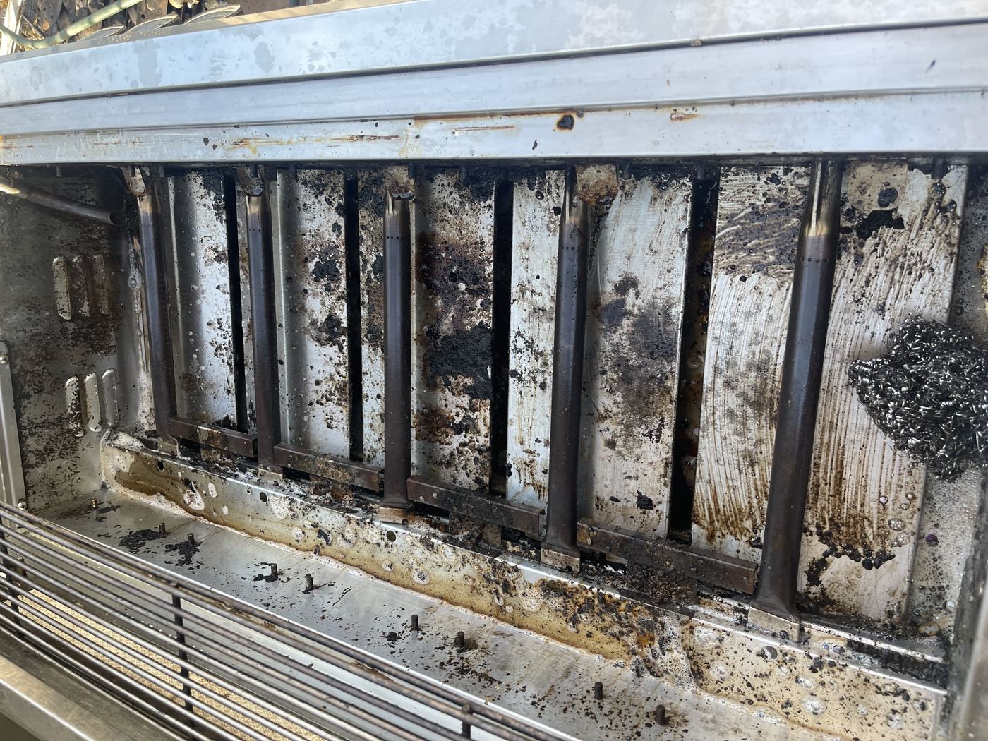 Commercial grill interior before deep cleaning
