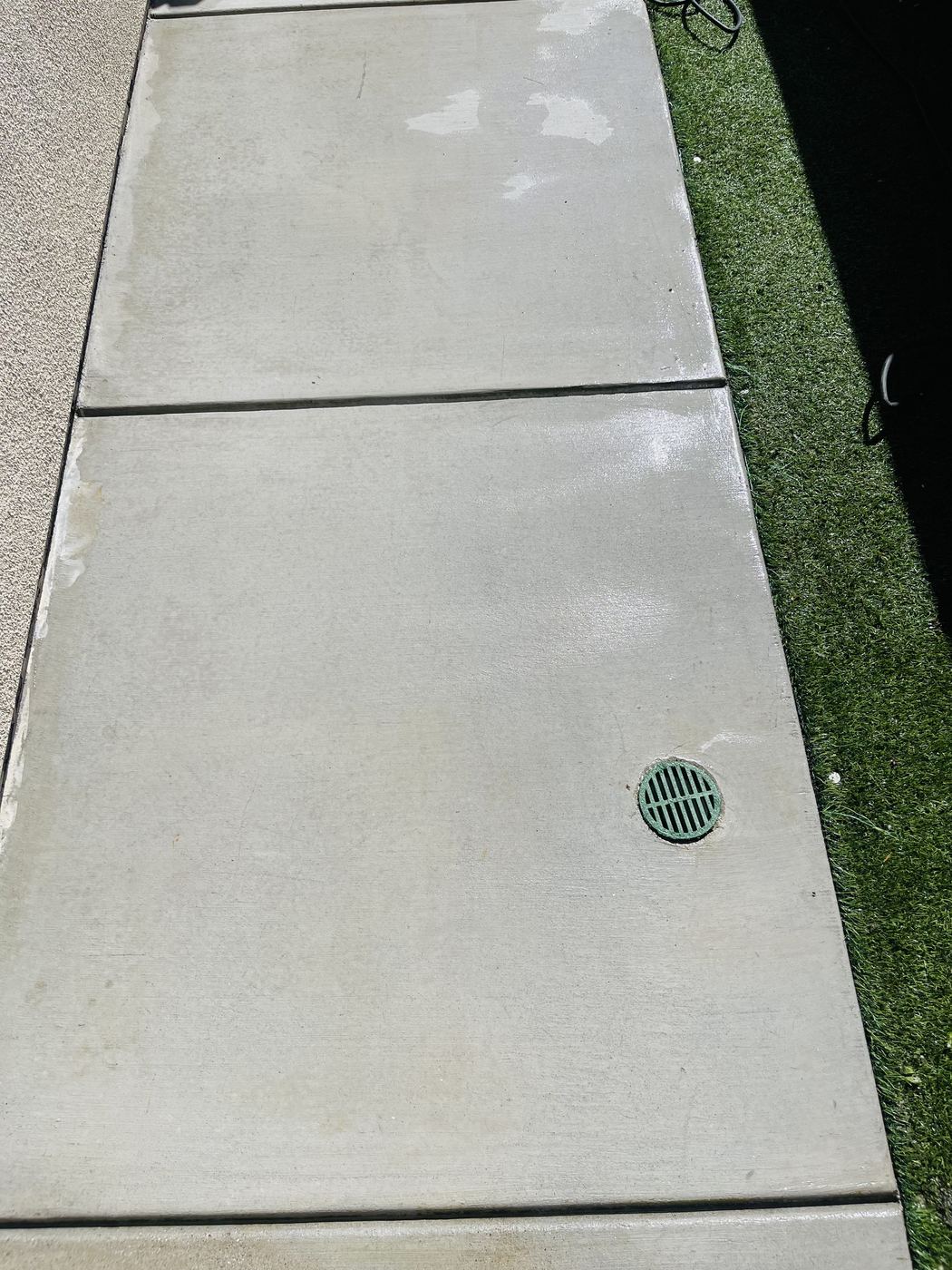 Clean concrete walkway after pressure washing